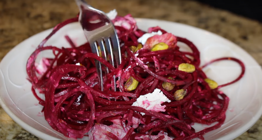 Grilled Chicken with Goat Cheese and Crushed Pistachios Over Beet Noodles